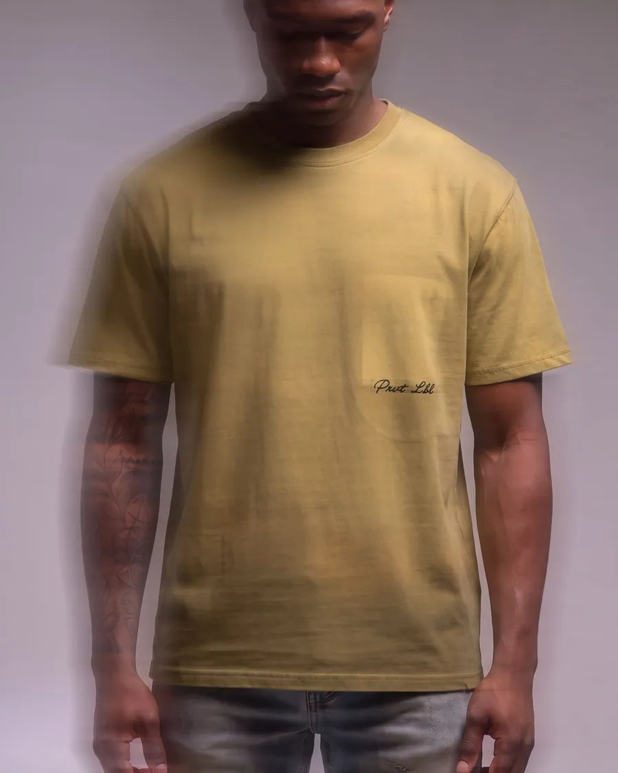 Model wearing a mustard PRVT LBL T-shirt