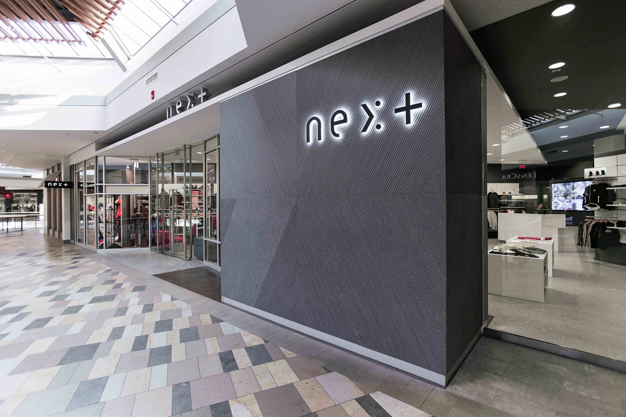 NEXT Beachwood storefront with its illuminated sign and glass entrance