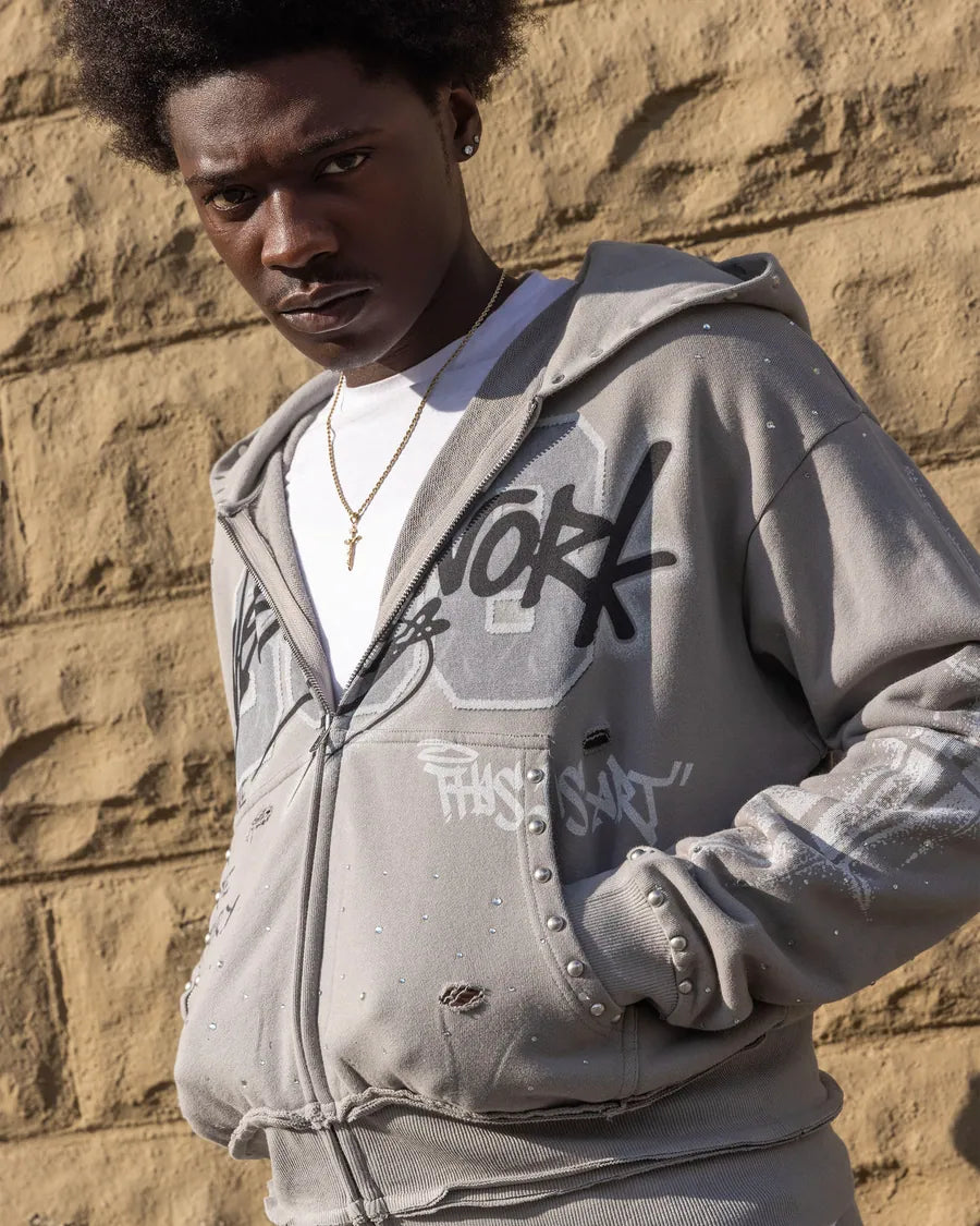 Model wearing a gray embellished Needlework hooded jacket